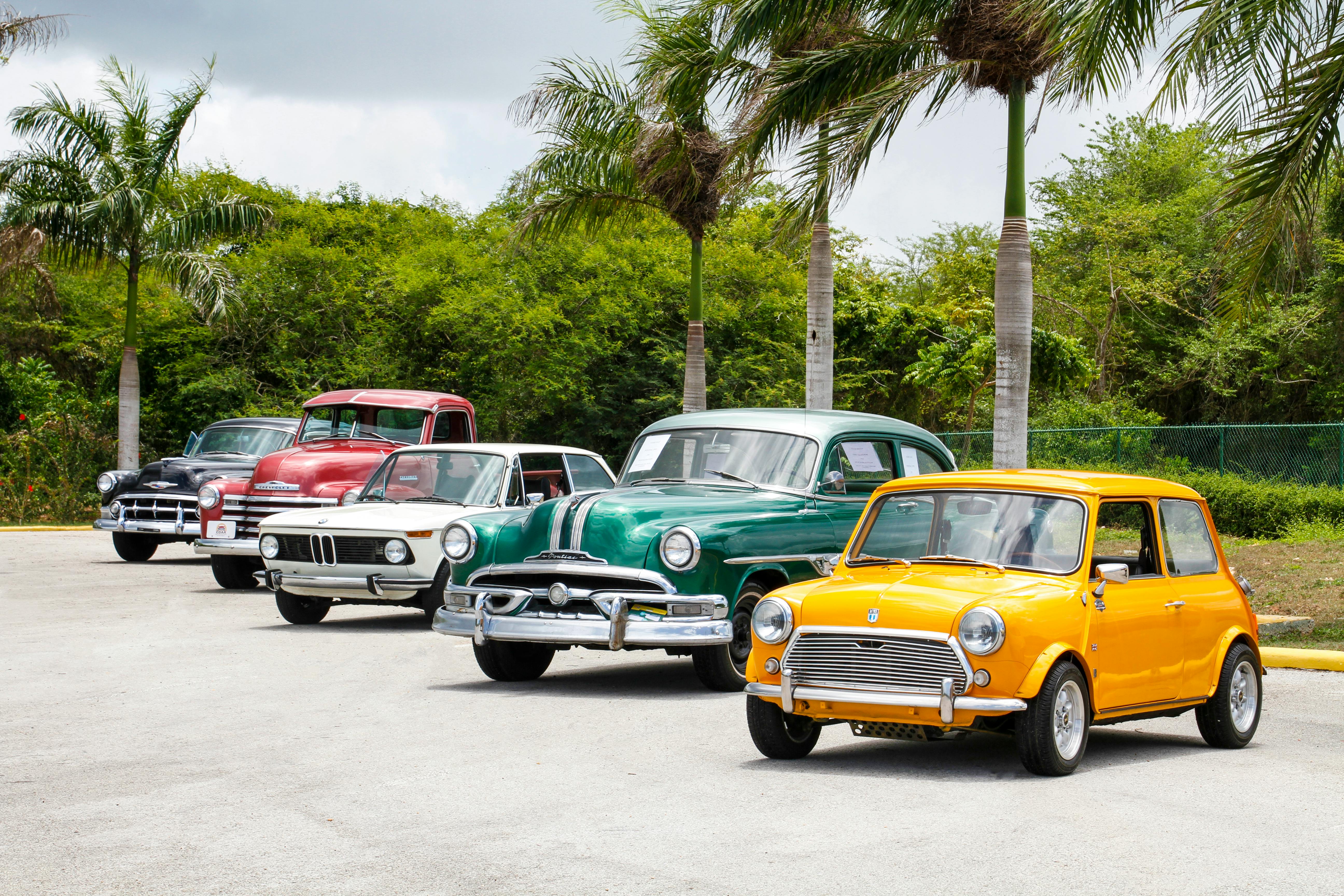 a line of oldish cars